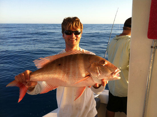 Guest holding a red snapper